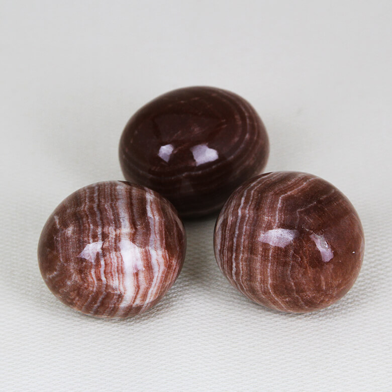 Red aragonite tumbled stones