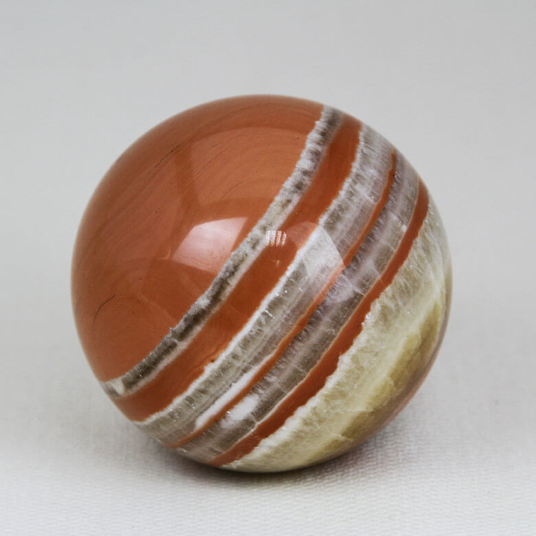 Peruvian Tiger Aragonite sphere with briliant glass-like polish