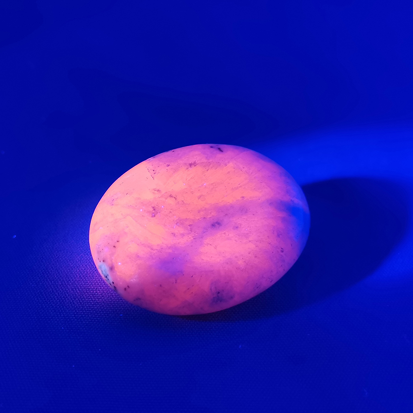 manganocalcite worry stone under UV light