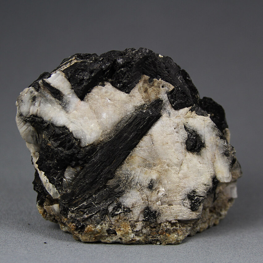 Unique mineral specimen of black tourmaline crystals in red fluorescent calcite - a exclusive stone of Gemrock Peru.