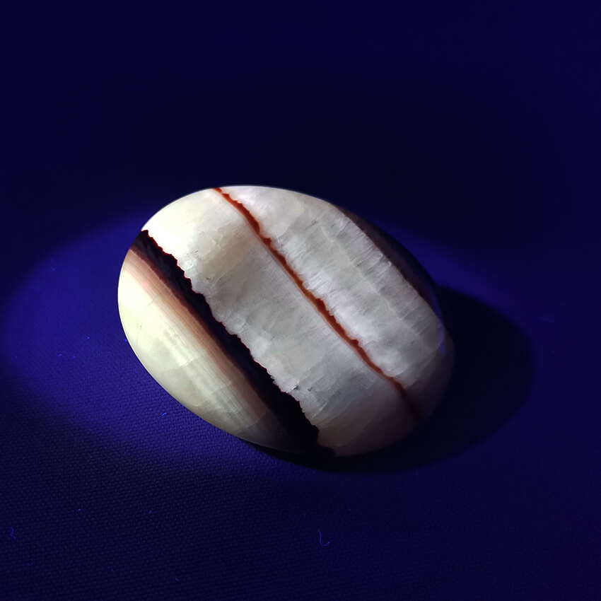 Tiger Aragonite worry stone ethical crystals Gemrock 01b fluorescent under UV light