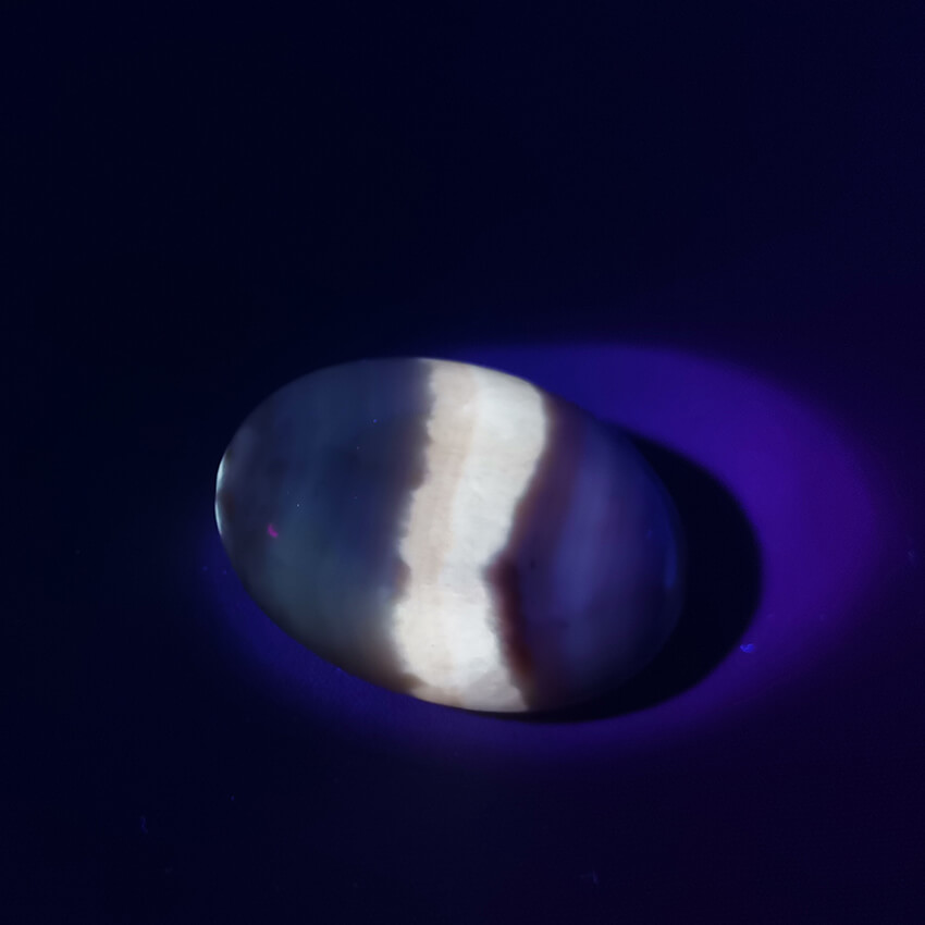 fluorescent coati aragonite worry stone under UV light ethical Crystals Gemrock 2